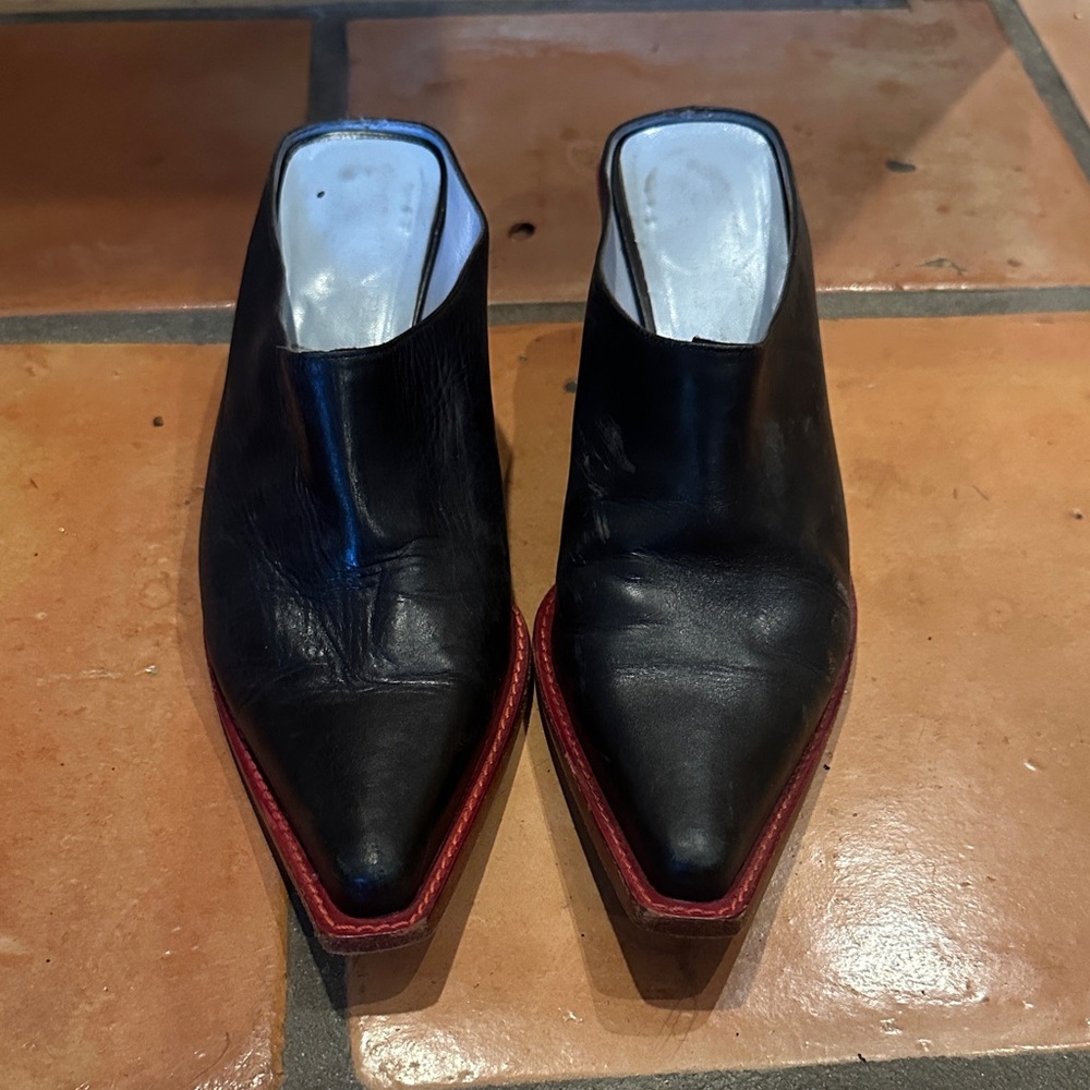 Cowboy boot style mule. Black with red detail.